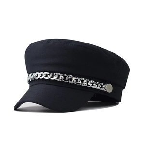 Detail of black cotton baker boy hat featuring a silver chain with sparkling rhinestones