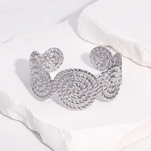 Adjustable silver stainless steel open bangle featuring vintage spiral rope disc designs