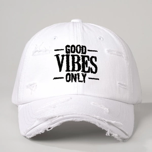 Close-up of distressed white cotton baseball cap with Good Vibes Only embroidery