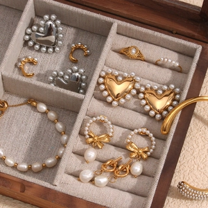 Detail view of 18K gold-plated pearl jewelry set inside a wooden storage box organizer