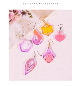 Macro shot of assorted DIY crystal resin earring pendants in various geometric shapes