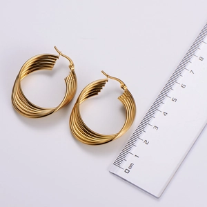 Detail view of gold layered twisted hoop earrings with ruler showing 3.5cm diameter size
