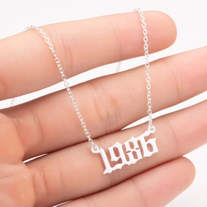 Detail view of 1986 stainless steel birth year pendant necklace in gothic font