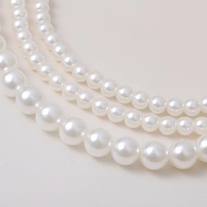 Macro shot of layered white pearl necklace with natural luster and gradient sizing