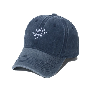 Navy blue washed denim baseball cap with sun embroidery from a 45-degree angle