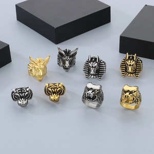 Macro shot of retro stainless steel animal head rings in gold and silver finishes