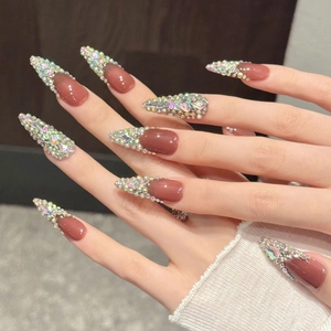 Luxurious stiletto press-on nails in reddish brown with colorful rhinestones for women
