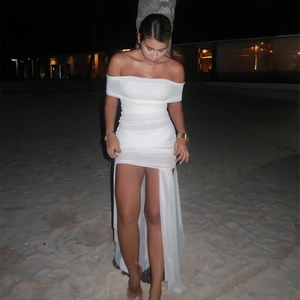 Detail of white off-shoulder ruched mesh dress with high slit and irregular hem