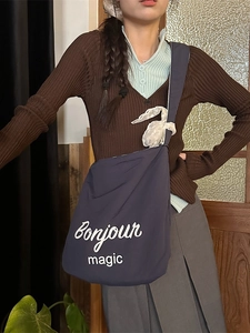Minimalist navy blue canvas bag with Bonjour print and lace trim on a female model