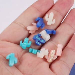 DIY cactus-shaped opal stone beads for jewelry making shown in hand under natural light