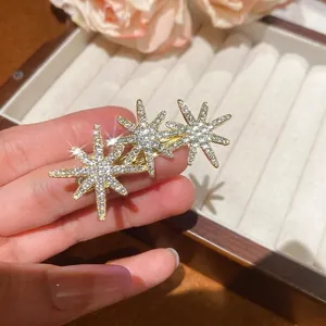 Elegant gold hair clip with three sparkling rhinestone star charms for women's hair styling