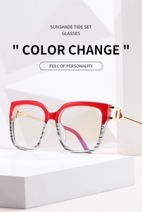 Detail view of red gradient frames with elegant gold metal temples on a clean background