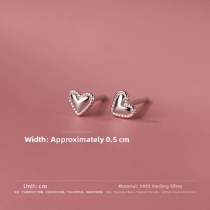 Macro shot of S925 sterling silver heart studs showing textured edges and 0.5cm width