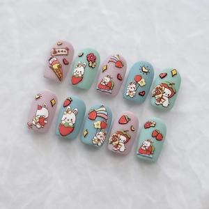 Kawaii 3D press-on nails with 10 pieces featuring pastel pink and mint green cartoon art