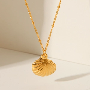 Close-up of 18K gold plated stainless steel shell pendant with elegant metallic texture