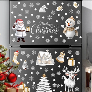 White Christmas snowflake and Santa window stickers set on a black refrigerator surface
