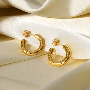Golden 18K stainless steel lava texture C-shape earrings on beige silk fabric