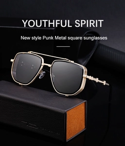 Detail of gold metal punk square sunglasses resting on a premium leather case