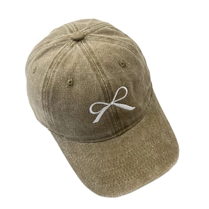 Détail de la broderie nœud sur une casquette de baseball en jean kaki délavé vintage