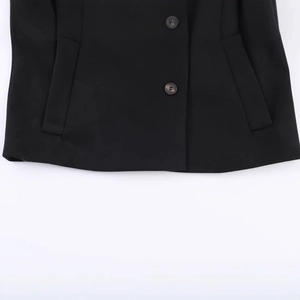 Women's black short coat with stand collar, detailed view of fabric and double button closure