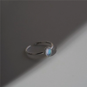 Detailed close-up of S925 silver ring featuring an iridescent oval stone and beaded edge