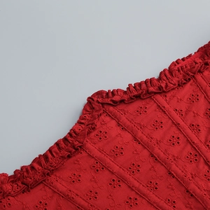 Macro shot of red Broderie Anglaise lace detail and ruffled edge on the slim waist dress