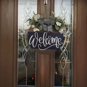 Detail of wooden welcome door sign with striped bow and artificial white flowers