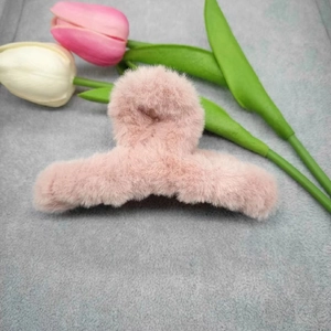 Detail shot of large 11cm pink plush shark hair claw clip with soft faux fur texture