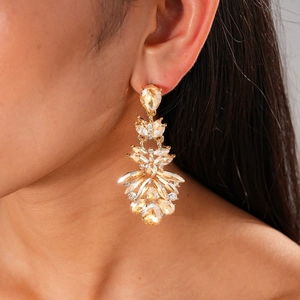 Champagne gold teardrop tassel earrings with crystals worn by a model in luxury style