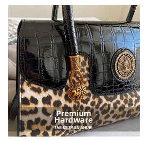 Detail of crocodile leather and leopard print with gold vintage hardware on luxury bag