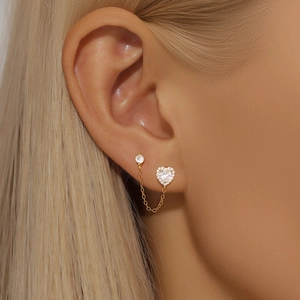Detail of S925 silver gold-plated double piercing chain earrings with heart and round zircon