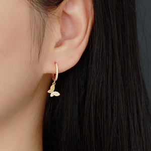 S925 silver gold butterfly hoop earring with white cubic zirconia worn on female model