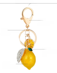Polished alloy lemon keychain detail with sparkling crystal rhinestones and golden clip