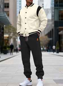 Detail of color-block baseball jacket with ribbed striped cuffs and button closure