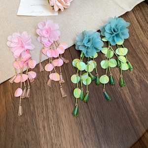 Detail of chiffon flower earrings with shimmering sequins and beads in pink and teal