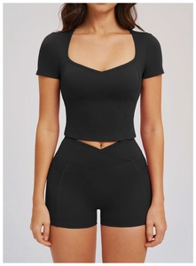 Detail of high-waisted crossover shorts with side pockets and slim-fit yoga top