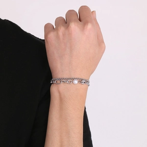 Double-layer stainless steel bracelet with white pearl on model's wrist