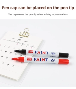 Detail of red and black paint markers with 2.8mm nibs and metallic finish bodies