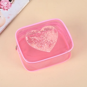 Pink translucent PVC makeup bag with heart shaped sequins and secure zipper closure