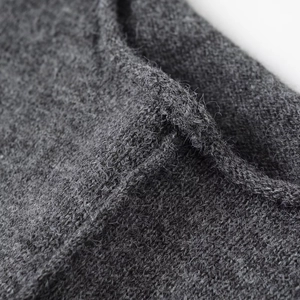 Detailed macro view of dark grey soft knit fabric texture for mini dress