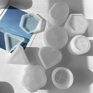 Various geometric silicone molds for resin including hexagon and heart shapes on white background