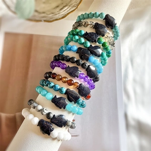 Detail of beaded bracelets with natural stone and cat shaped glittery stone pendants