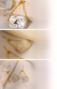 Detailed view of baroque freshwater pearl earrings with 18K gold plating and crystal inlay