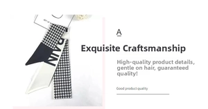Macro shot of black and white houndstooth pattern silk hair scarf with RAIN typography