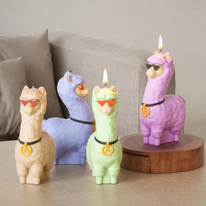 Set of four colorful alpaca candles with sunglasses and faux fur texture on a sofa