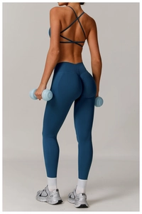Detail view of high waist scrunch butt leggings and crisscross back sports bra in teal