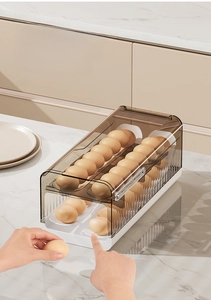 Detailed view of dual-layer rolling egg tray with gravity slide and clear brown lid