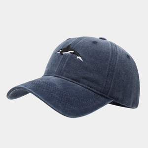 Close-up of detailed orca embroidery on vintage washed cotton baseball cap