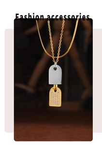 Detail of square two-tone pendant necklace with sparkling diamonds on a sleek snake chain