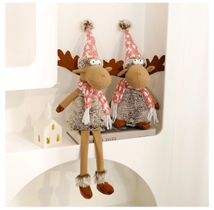 Detail of Christmas reindeer plush dolls with snowflake knit hats in a cozy home setting